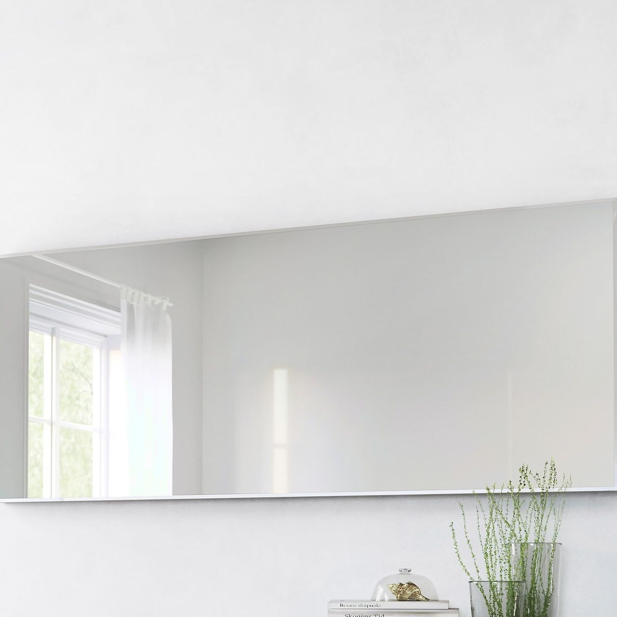 Wavy mirror: Irregularly-shaped reflective household product.